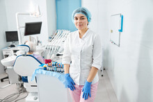 Female Dentist In Scrubs Staying Inside Her Office