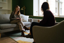 Female Psychologist Listens To Her Client During A Therapy Session
