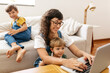 Woman working on laptop at home with kids