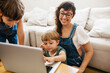 © (JLco) Julia Amaral - Happy family with laptop at home