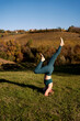© Mauro Grigollo Photographer/Stocksy - Woman taking time for herself and relaxing in nature, doing yoga at sunset