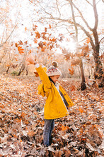 Girl Playing Throwing Dry Leaves