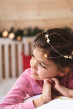 Festive Portrait Of A Cute Girl Wearing Fairy Lights In Her Hair