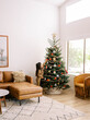 © Daniel Kim Photography/Stocksy - Child decorating Christmas Tree in home