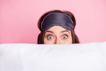 Wall Mural - Photo portrait of scared girl hiding behind pillow isolated on pastel pink colored background