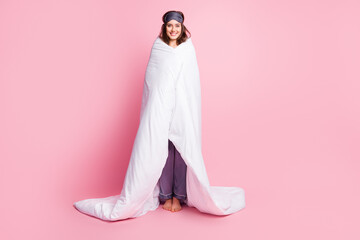 Wall Mural - Photo portrait full body view of girl covered in bed sheets isolated on pastel pink colored background