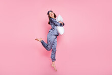 Full Length Body Size Photo Of Girl Wearing Pajama Hugging Embracing Pillow Jumping Isolated On Pastel Pink Color Background