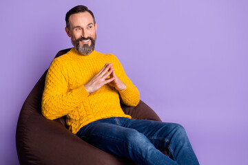 Poster - Profile side photo of mature man happy positive smile sit bean chair look empty space isolated over violet color background