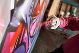 Fototapeta Młodzieżowe - Street artist painting colorful graffiti