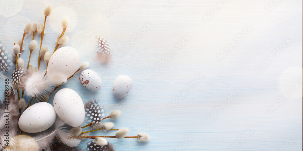 Art Flat lay Easter composition with a willow branch and eggs on a blue background - obrazy, fototapety, plakaty 