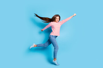 Wall Mural - Full length body size photo flying super woman ready to rescue wearing casual outfit isolated vibrant blue color background