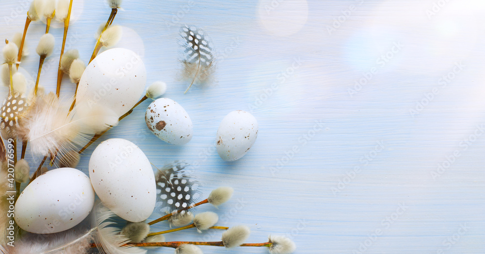 Flat lay Easter composition with a willow branch and eggs on a blue background - obrazy, fototapety, plakaty 