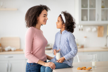 Wall Mural - Little Black Girl And Afro Woman Drinking Milk