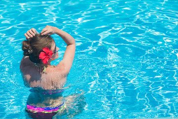 Wall Mural - Young woman sitting in the pool in luxury resort,