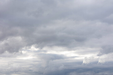 Wall Mural - gray stormy sky with fluffy clouds, abstract background