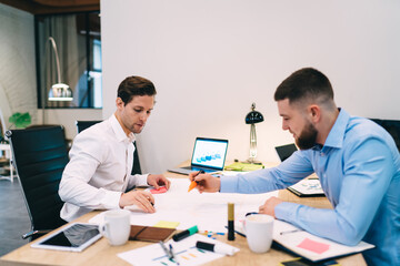 Wall Mural - Stylish men sharing ideas during work in office