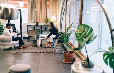 Concentrated diverse colleagues working and discussing business