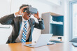 © Mego-studio - Businessman using virtual reality glasses.