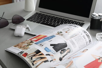 Sticker - Workplace with fashion magazine on grey table, closeup