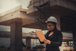 © reewungjunerr - Engineer woman working at site of bridge under construction