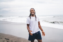 Excited Black Man Standing On Beach