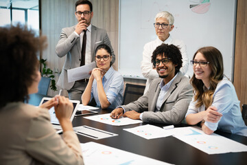 group of business people working together, brainstorming in office