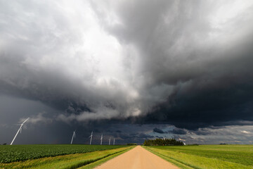 Wall Mural - Storm clouds over a dirt road and field
