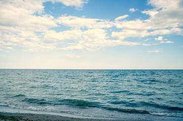 Seascape background wavy blue sea and sky with clouds