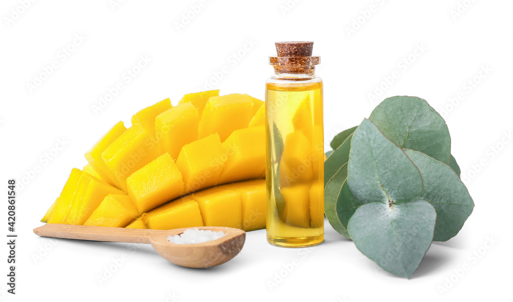 Bottle of essential oil, eucalyptus and fresh mango on white background