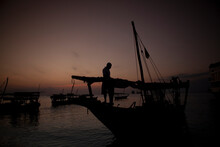 Silhouette Of Fisherman On Boat