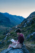 © Connect Images - Boy reading book on hilltop, Snowdonia, Llanberis, Gwynedd, UK