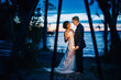 © Connect Images - Bride and groom with sparklers by lakeside at dusk, Lake Ontario, Toronto, Canada