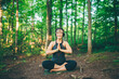 © Connect Images - Woman doing prayer pose in forest