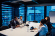 © Connect Images - Businessmen and women having discussion over conference table meeting