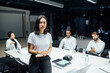 © Connect Images - Young businesswoman in front of team at conference table meeting, portrait
