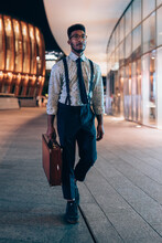 Businessman Walking Past Buildings In City, Milano, Lombardia, Italy