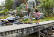© Connect Images - Grandfather and grandson walking on bridge