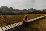 Fototapeta Londyn - Woman relaxing on trail path, Queenstown, Canterbury, New Zealand
