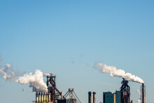 Smokestacks From Steel Industry Blast-furnaces Against Blue Sky, Netherlands