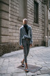 © Connect Images - Stylish man standing by period building, Milan, Italy