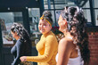 © Connect Images - Young woman and her teenage sisters walking and talking on street