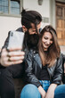 © Connect Images - Couple taking selfie on steps
