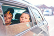 © Connect Images - Two teenage girls in car back seat looking out of car window