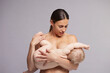 © Connect Images - Mother gently calming baby to breastfeed