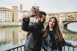 © Connect Images - Couple taking selfie on bridge, Ponte Vecchio, Firenze, Toscana, Italy