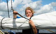 Girl Prepares Sails On Flat-bottom Traditional Sailing Ship, Sneekermeer, Friesland, Netherlands