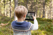 © Connect Images - Boy taking photograph of forest