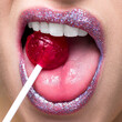 © Connect Images - Shimmering lips biting on lollipop