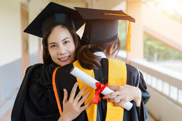 Sticker - The Asian university graduates in graduation gown and a mortarboard cap with a degree certificate in hand celebrating education achievement in the commencement ceremony. Congratulations to graduations