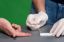 Close Up Of Medical Staff Performing A Corona Virus Antibody Test On Patient Taking Blood. 